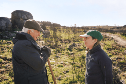 Senior community members sharing traditional land knowledge during a Land Life tree restoration project.